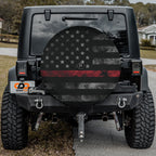 Thin Red Line Subdued American Flag spare tire cover on a black Jeep Wrangler displaying the muted firefighter tribute