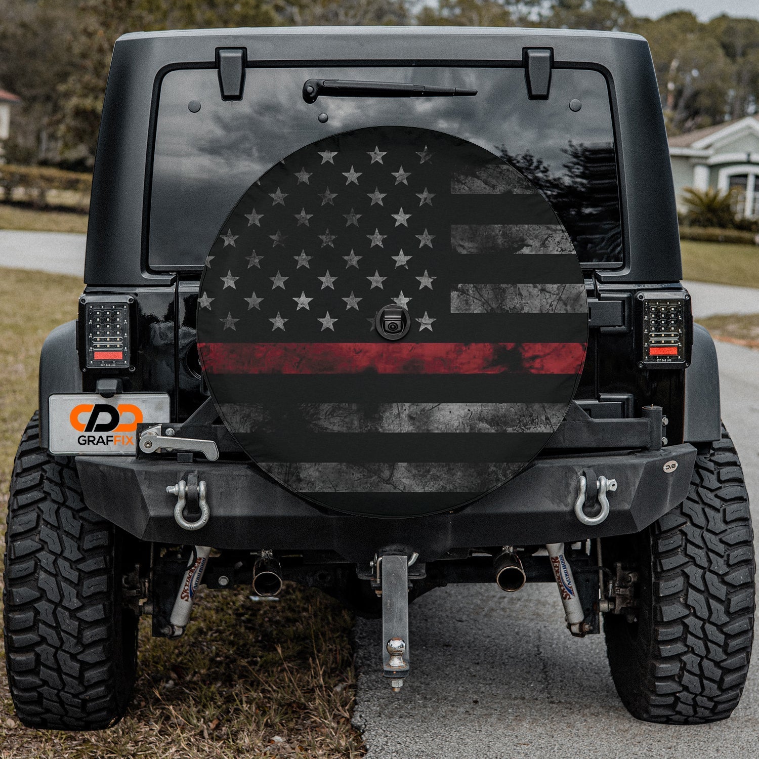 Thin Red Line Subdued American Flag spare tire cover on a black Jeep Wrangler displaying the muted firefighter tribute