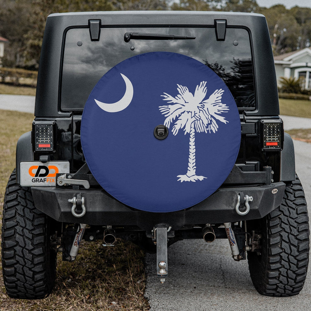South Carolina palmetto moon spare tire cover fitted on red Jeep Wrangler with desert mountain background