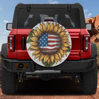 Star-Spangled Sunflower spare tire cover on a red Jeep Wrangler showing the patriotic flag-and-bloom rear design