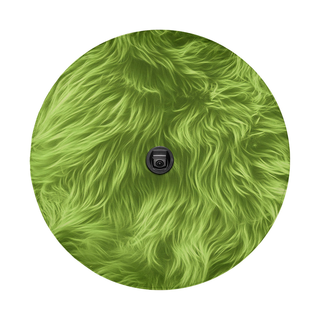 a close-up view of a fuzzy, green surface with a small black object in the center.