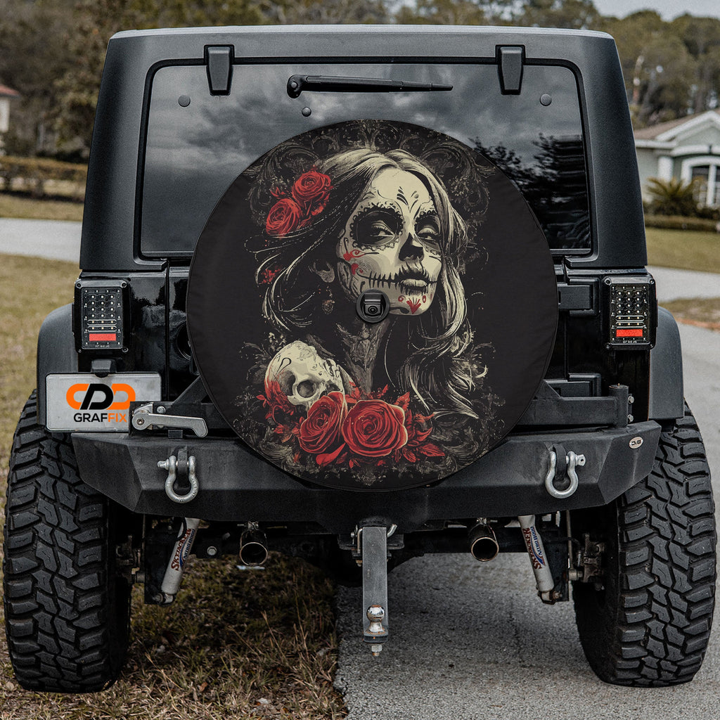 Dia de los Muertos Beauty spare tire cover with painted skull face design mounted on Jeep tailgate