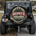 the back of a black Jeep Wrangler with a large shark decal on the rear window.