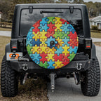 Spectrum of Unity spare tire cover on black Jeep Wrangler rear with rainbow puzzle piece spare cover