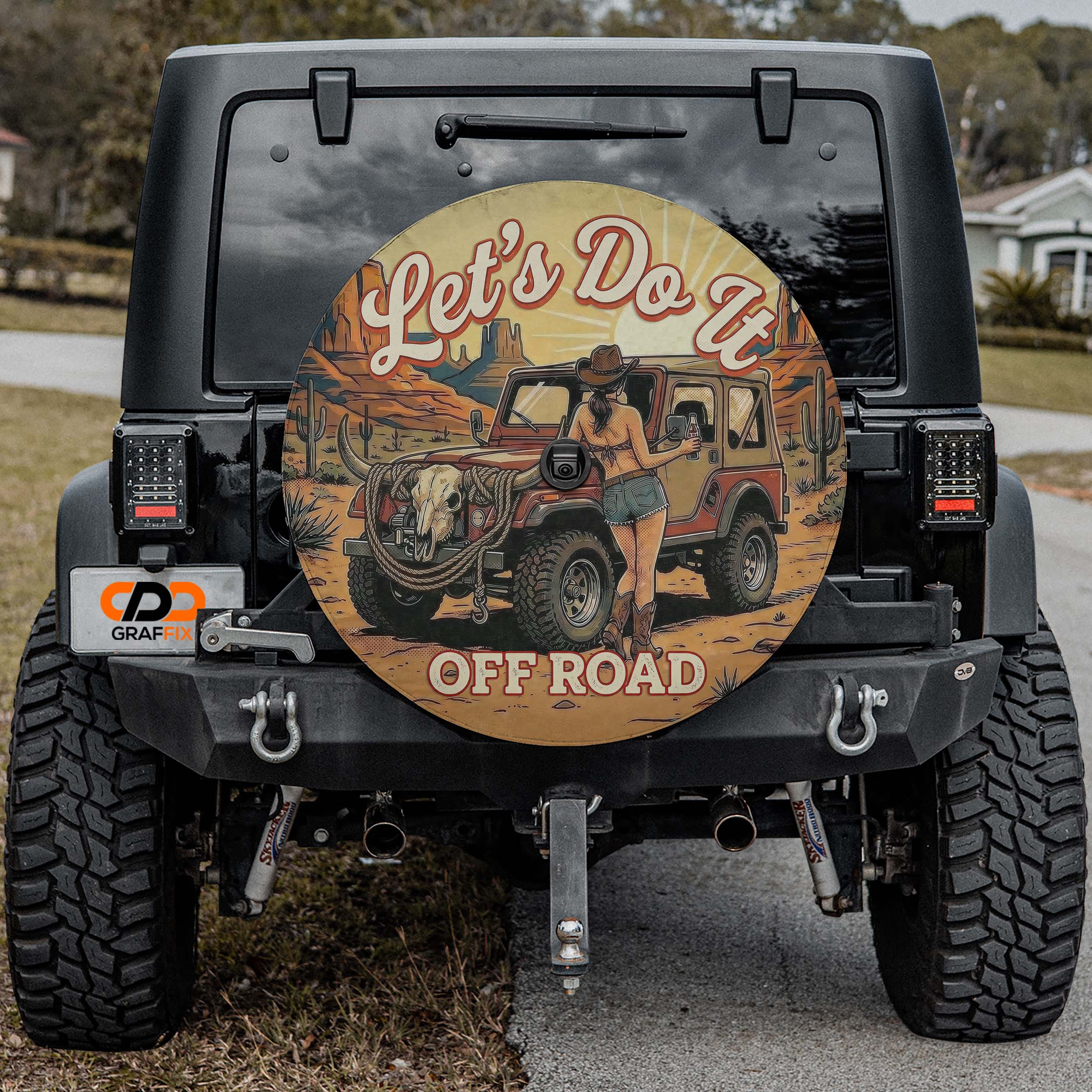a black Jeep Wrangler with a large, round decal on the rear window that says "Let's Do It" and "Off Road".