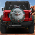 Jolly Holly Yeti spare tire cover on a red Jeep Wrangler with smiling white yeti and red holly