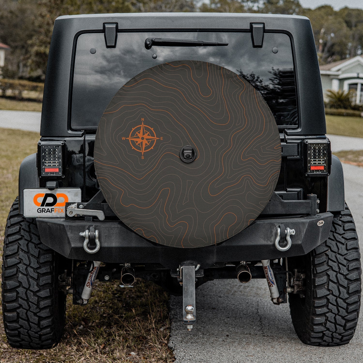 Topographic map tire cover flat round view with orange compass rose and elevation contour lines on dark gray