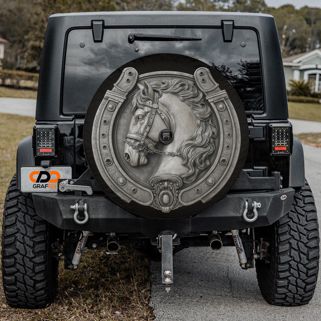 the rear of a black Jeep Wrangler with a large, decorative wheel cover featuring a horse's head and a horseshoe design.