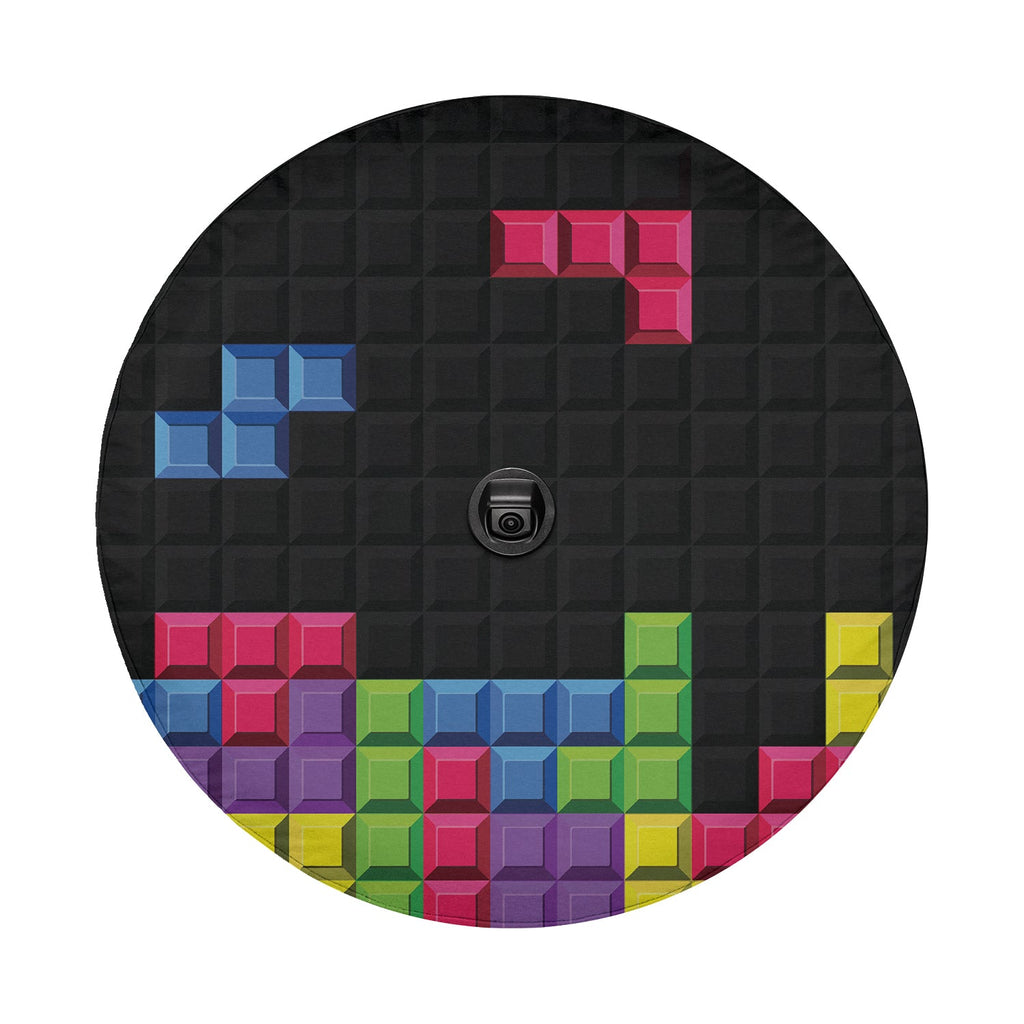 Pixel block puzzle tire cover on black Jeep Wrangler displaying multi-color retro arcade brick stack pattern