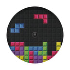 Pixel block puzzle tire cover on black Jeep Wrangler displaying multi-color retro arcade brick stack pattern