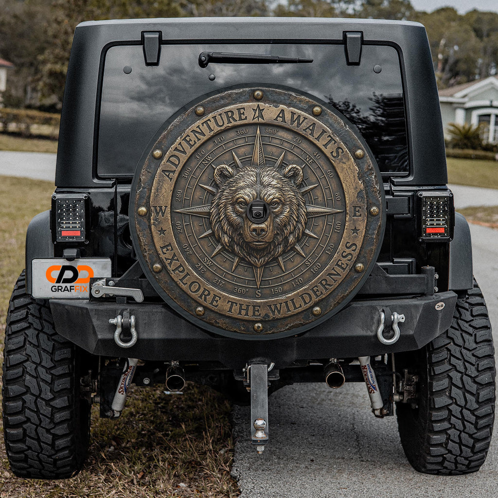 the back of a black Jeep Wrangler with a large, decorative metal shield on the rear window.