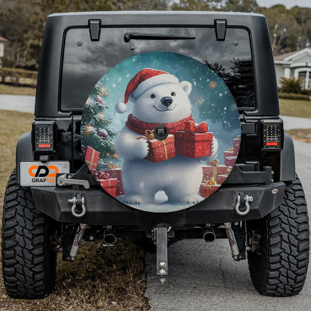 Winter Wonderland Bear spare tire cover on a Jeep rear wheel with a polar bear cradling a wrapped Christmas gift