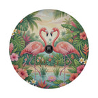 A vibrant illustration of two pink flamingos standing in a tropical garden, surrounded by lush foliage, flowers, and palm trees.