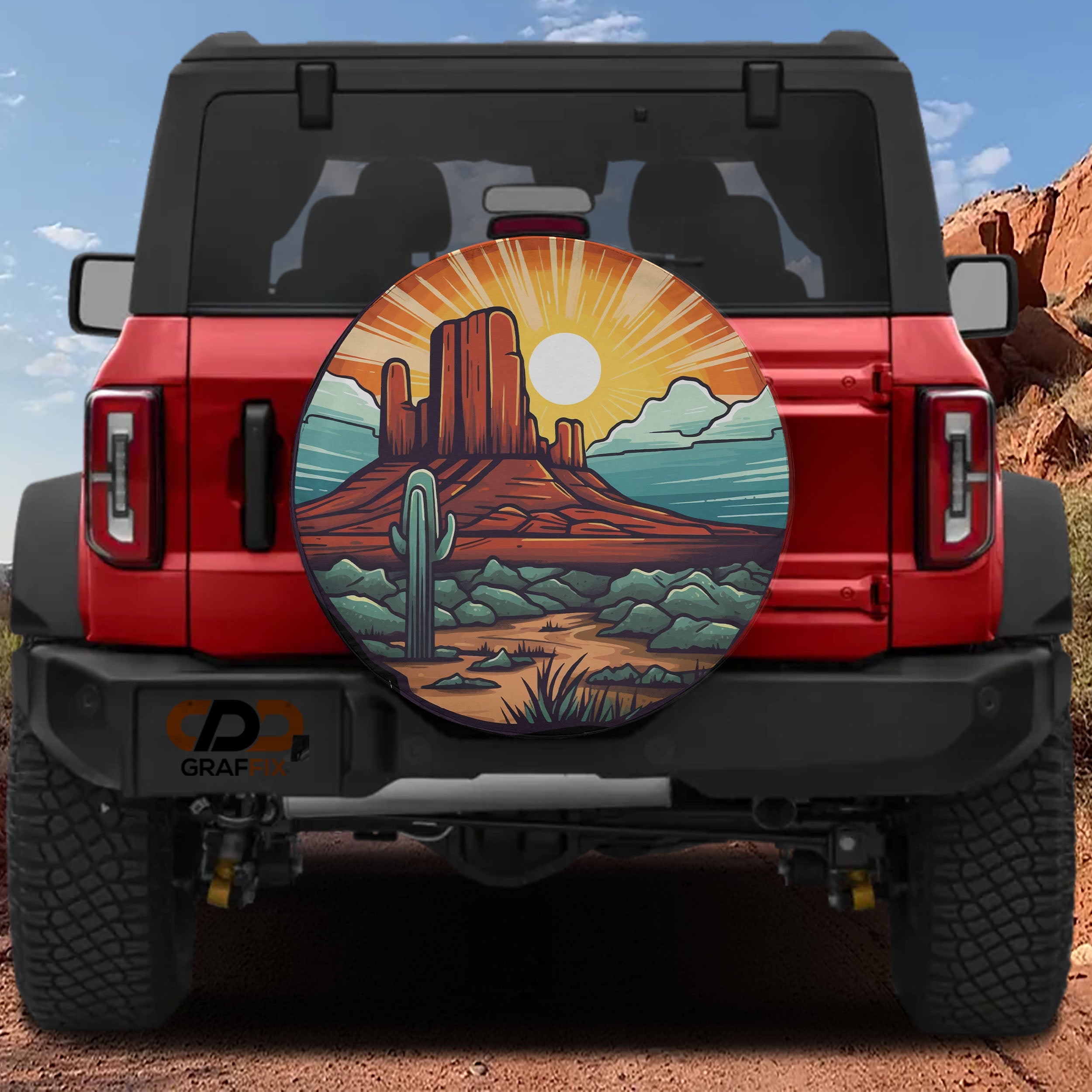 Sunset Over Sedona tire cover on a red Ford Bronco showing desert mesa cactus sunburst and turquoise sky