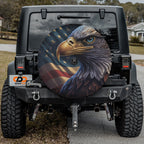 Patriotic bald eagle spare tire cover installed on a Jeep Wrangler showing American flag backdrop