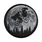 A silhouetted image of a man riding a bicycle against the backdrop of a full moon, with a woman riding a bicycle in the background.