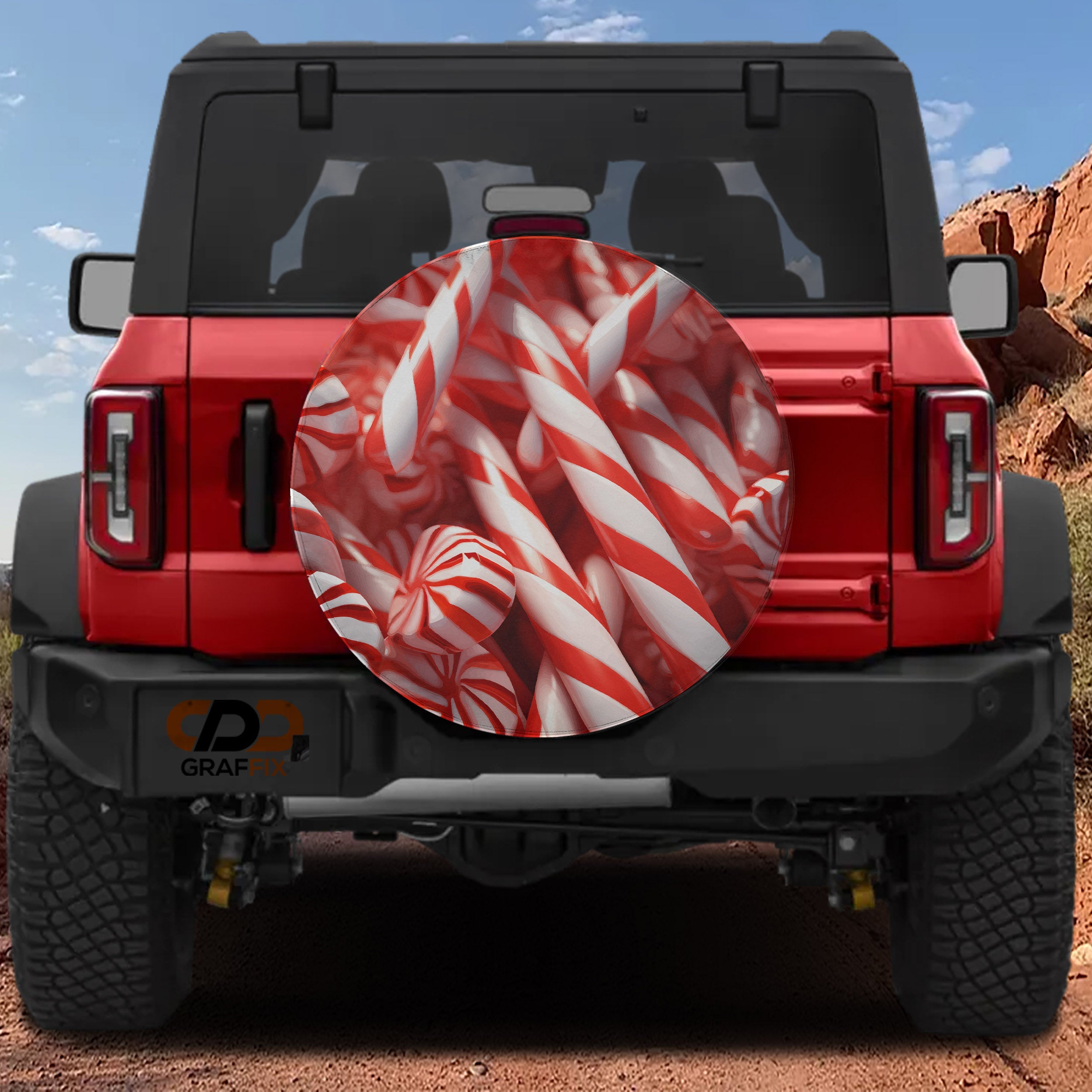 Peppermint Christmas candy cane spare tire cover on red Ford Bronco with red white striped candies