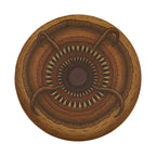 The image is a circular design with a central motif featuring a large, intricate pattern of small, overlapping shapes and lines.