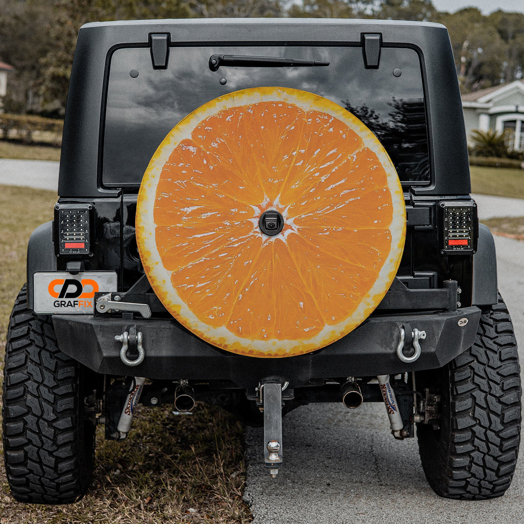 Orange fruit spare tire cover with vibrant citrus slice graphic and bright orange peel design