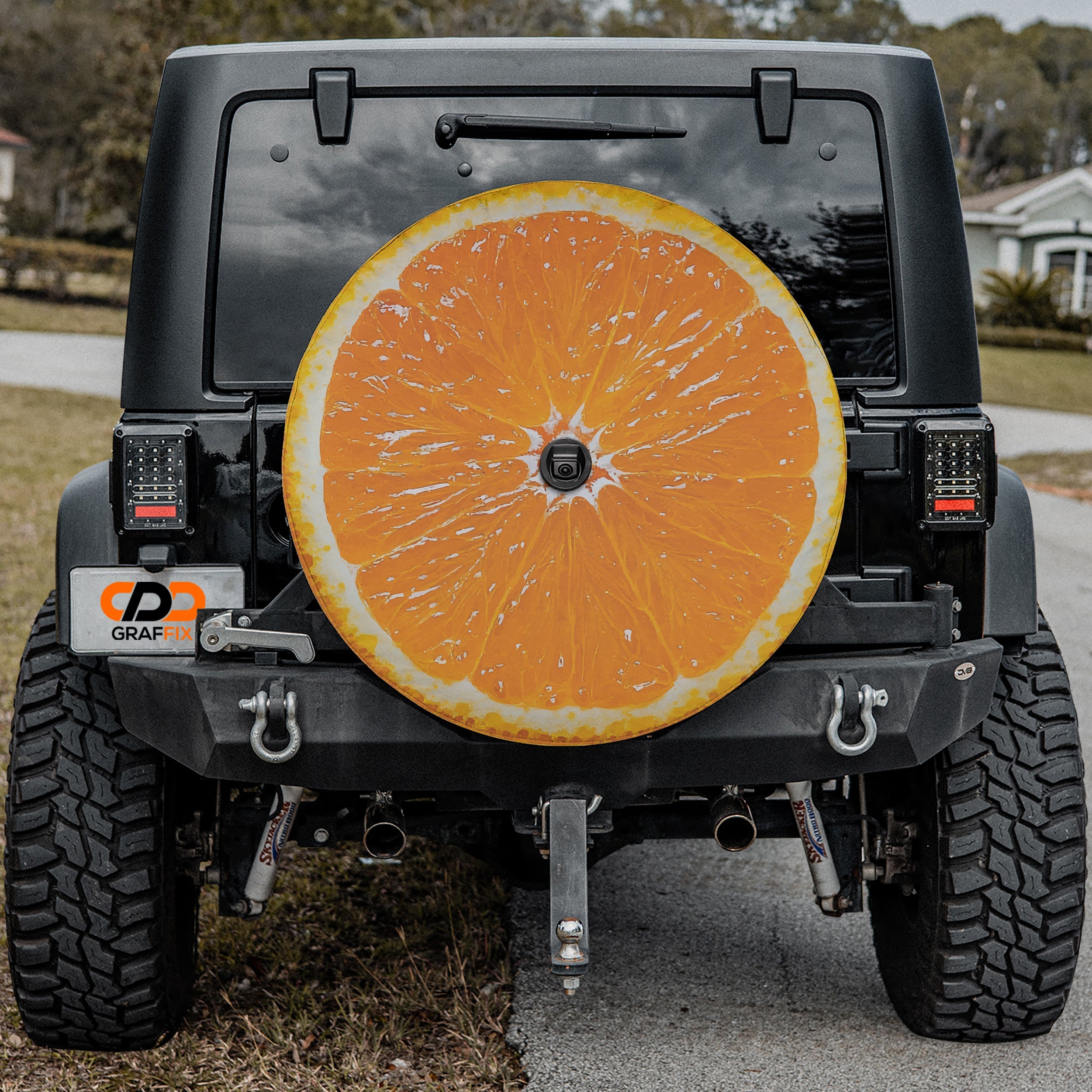 Orange fruit spare tire cover with vibrant citrus slice graphic and bright orange peel design