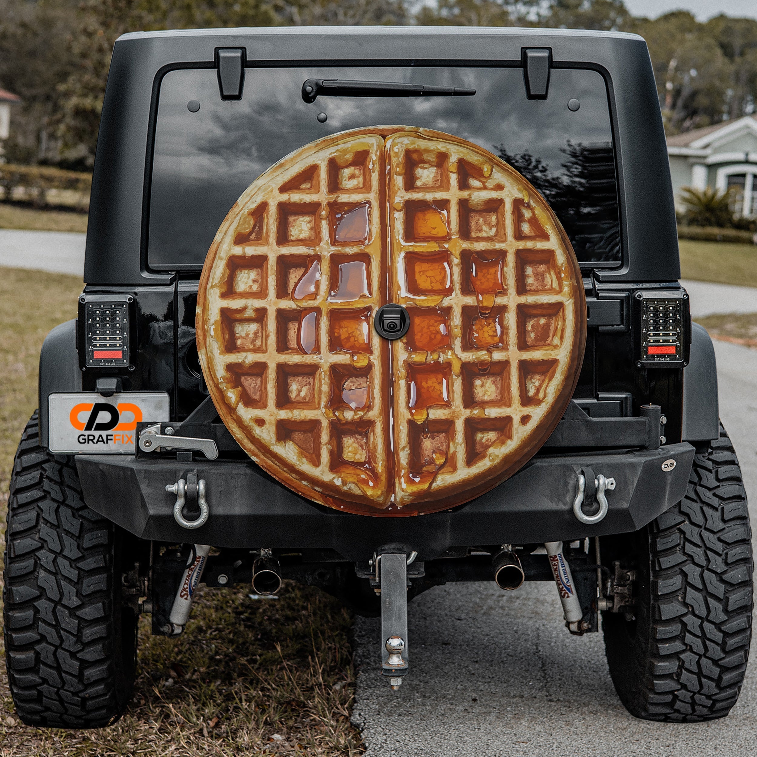 Maple syrup Belgian waffle spare tire cover mounted on black Jeep Wrangler rear outdoors