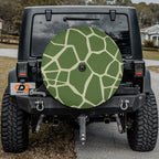 Turtle Trek spare tire cover on a black Jeep Wrangler rear hatch with the green turtle shell scute pattern art