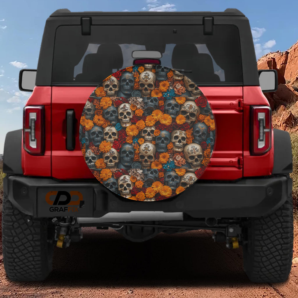 Flowers and skulls tire cover on red Ford Bronco showing Day-of-the-Dead style marigolds and skull pattern