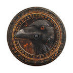 a close-up of a black bird, possibly a crow, with a camera lens in the center of a circular frame.