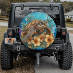 a black Jeep Wrangler with a large, colorful wheel cover depicting a sea turtle and tropical flowers.