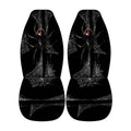 a pair of black car seat covers with a spider design on them.