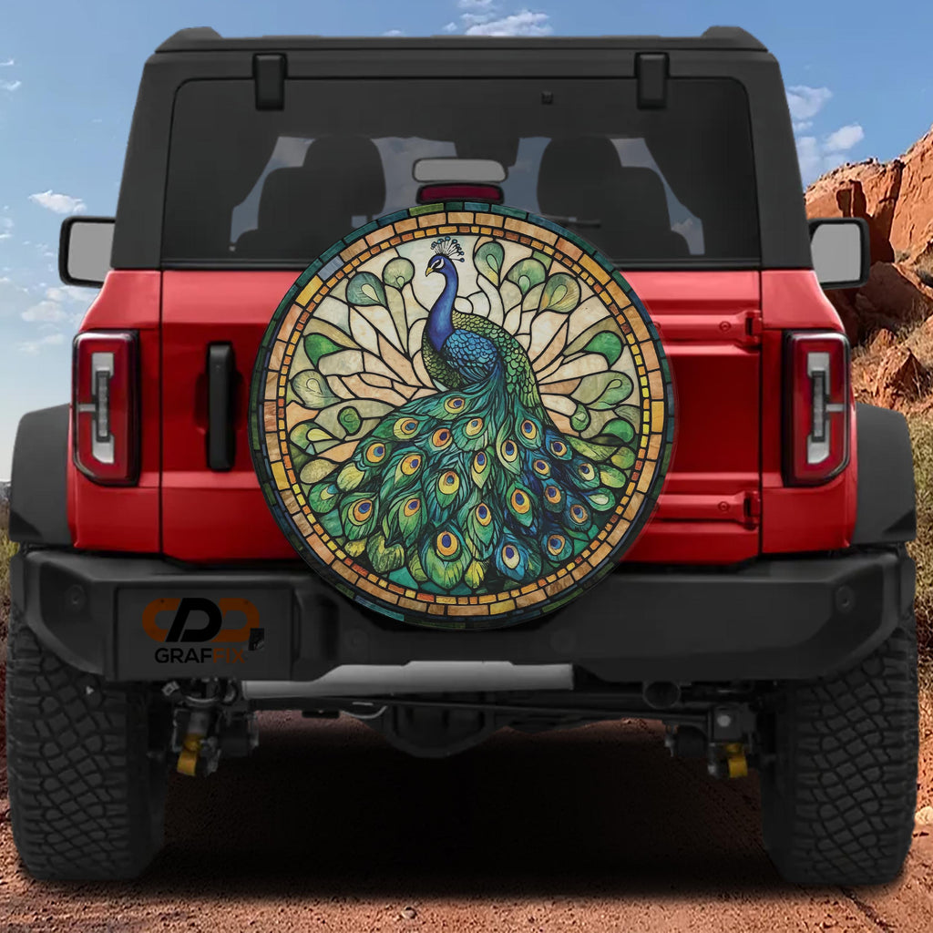 Peacock stained glass mosaic spare tire cover on red Ford Bronco with blue green feather plumage