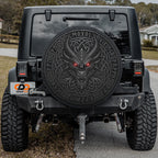 a black Jeep Wrangler with a large, detailed dragon decal on the rear window.