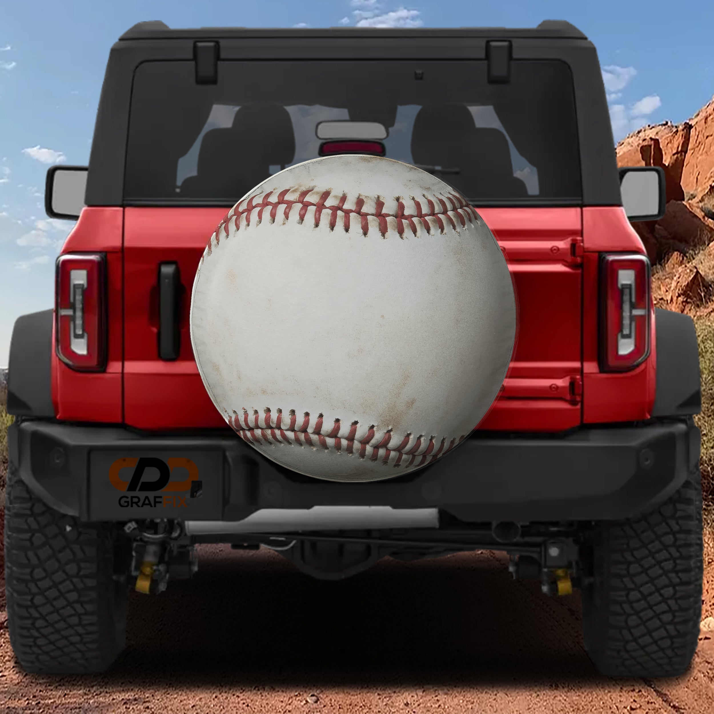 Baseball spare tire cover rear angle view on parked Jeep with backup camera cutout