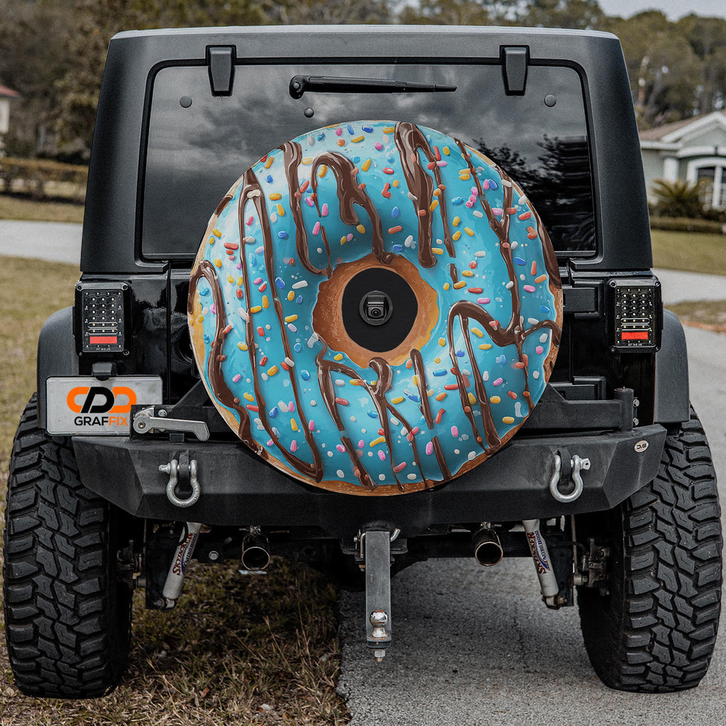 a black Jeep Wrangler with a large, colorful donut-shaped air freshener attached to the rear of the vehicle.