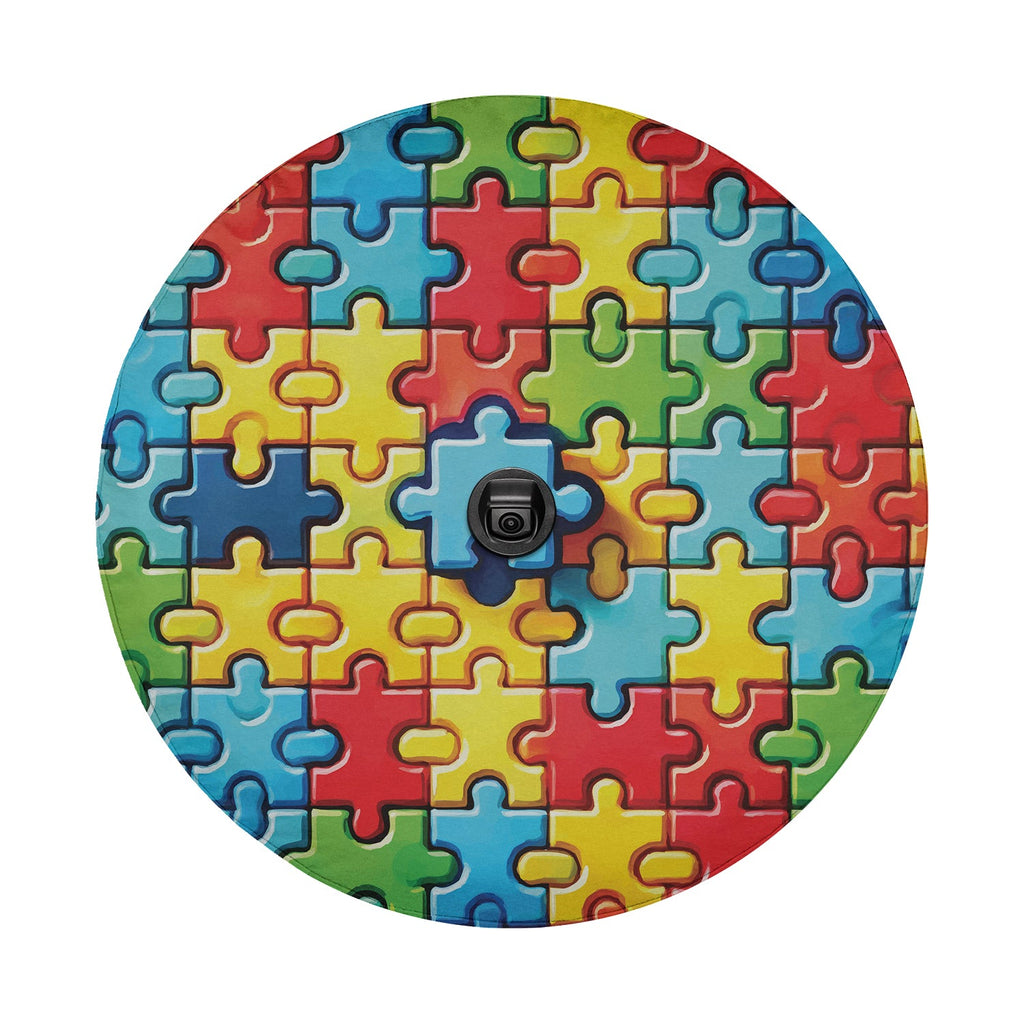 Spectrum of Unity spare tire cover detail showing autism puzzle pieces and central camera cutout