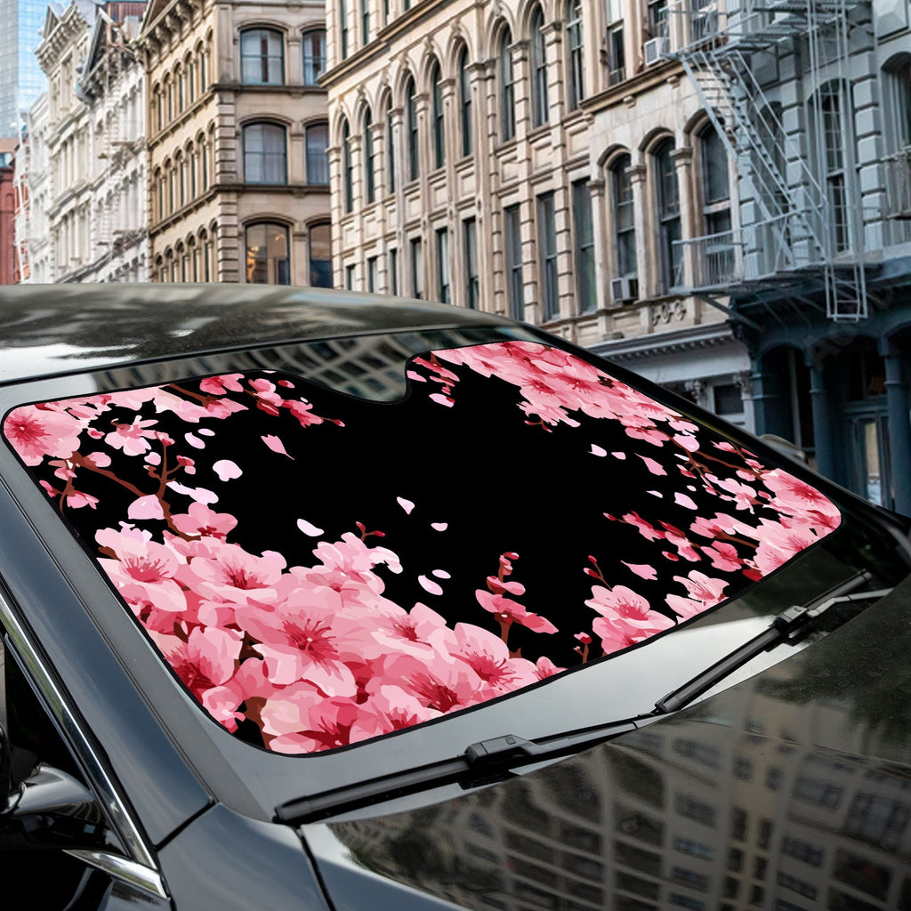 Japanese Cherry Blossom accordion sunshade close-up installed on a dark sedan windshield exterior detail