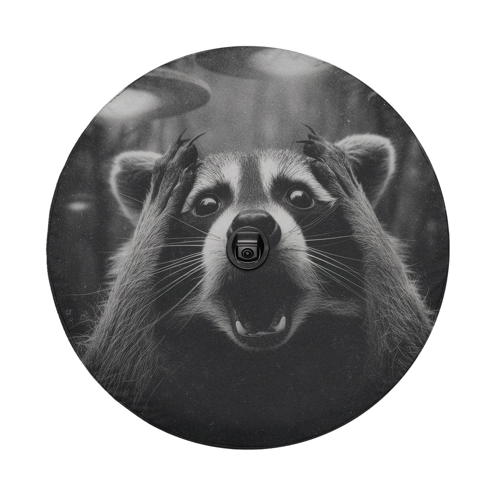 A raccoon with its paws covering its face appears to be looking surprised or startled, with a camera attached to its nose.