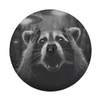 A raccoon with its paws covering its face appears to be looking surprised or startled, with a camera attached to its nose.