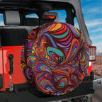 Kaleidoscopic Abstract Dream rainbow swirl tire cover mounted on red Ford Bronco rear with red rocks