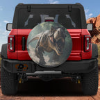T-Rex charging dinosaur spare tire cover on red Ford Bronco with roaring Tyrannosaurus prehistoric
