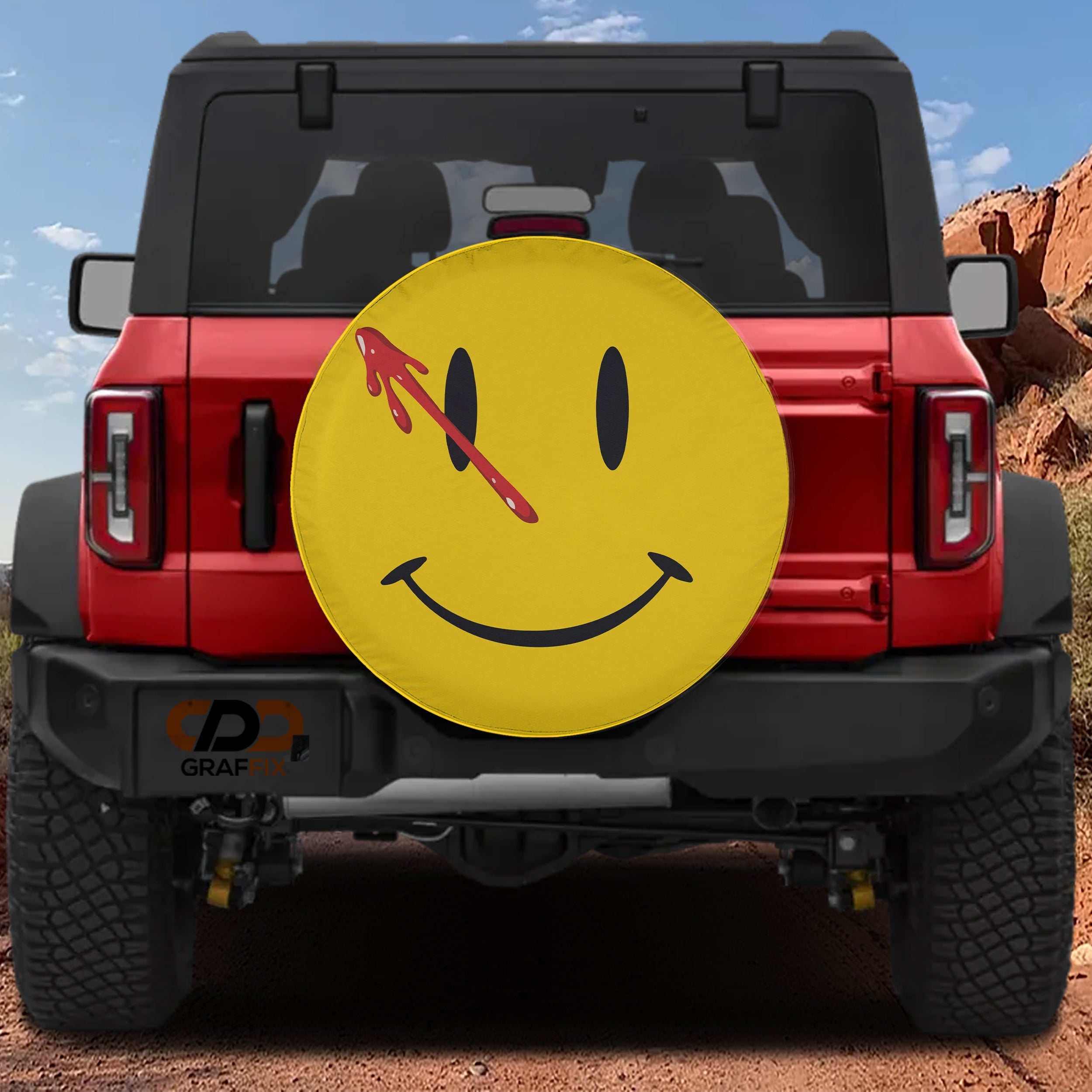 Comedian Smiley Face spare tire cover with yellow face red blood drip across left eye and dark smile