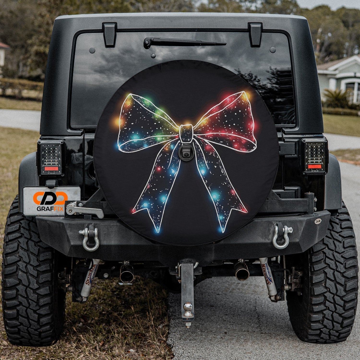 Christmas Lights Bow tire cover product photo of festive multicolor light bow on solid black backdrop