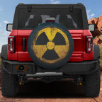 Flat fallout shelter radiation symbol spare tire cover artwork in distressed yellow and black grunge style