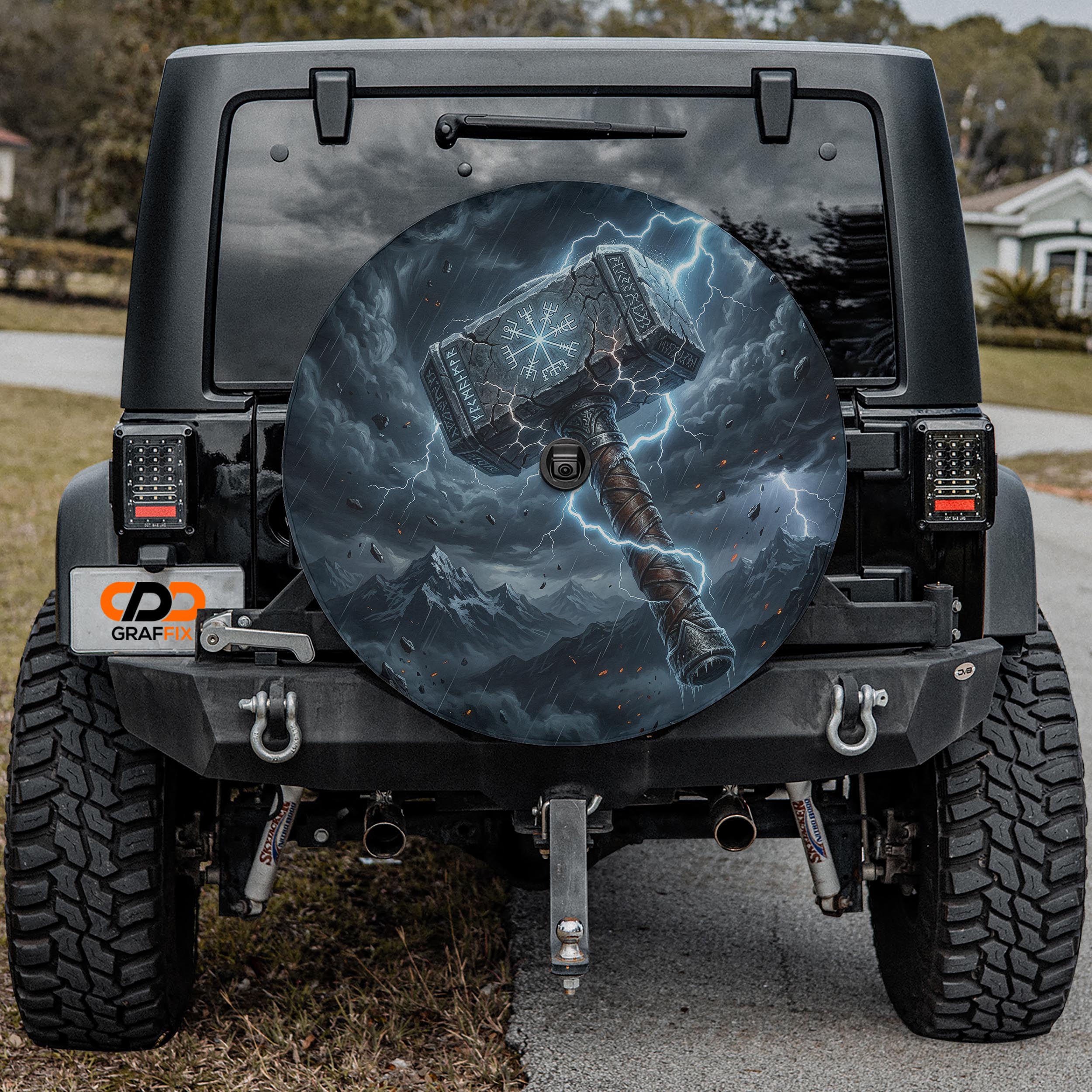 a black Jeep Wrangler with a large, detailed decal of a hammer on the rear window.