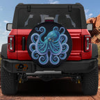 a red Jeep Wrangler with a large octopus-themed spare tire cover on the rear.