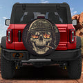 Burning reflections army skull spare tire cover on a black Jeep Wrangler with GRAFFIX bumper sticker