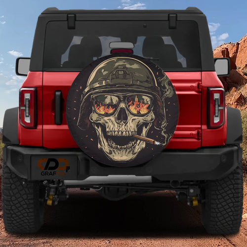 Burning reflections army skull spare tire cover on a black Jeep Wrangler with GRAFFIX bumper sticker