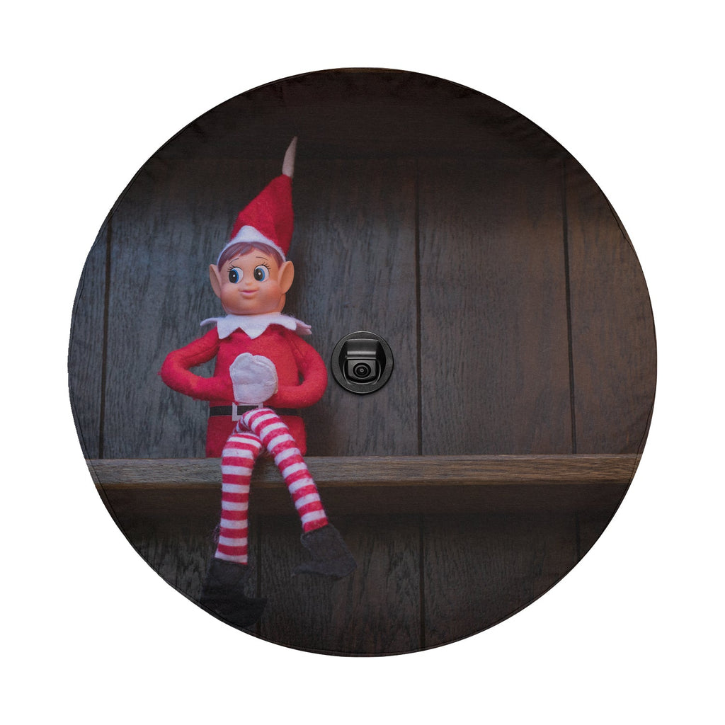 Shelfside Shenanigans spare tire cover flat art with a smiling elf seated on a snowy shelf for Christmas Jeep style