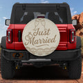 Just Married spare tire cover on red Ford Bronco with champagne flutes ring script design
