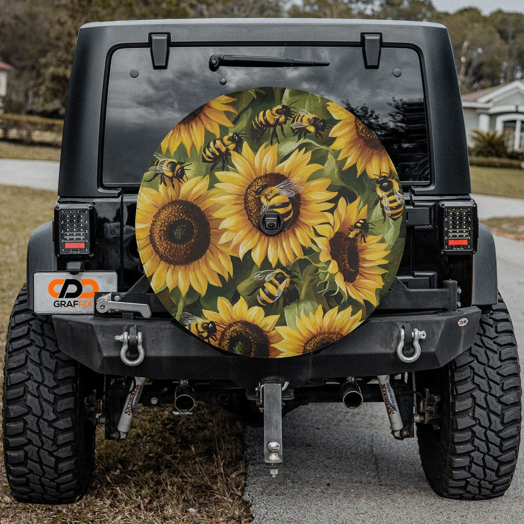Sunflower bumblebee tire cover on a black Jeep Wrangler featuring a yellow honeybee garden pattern